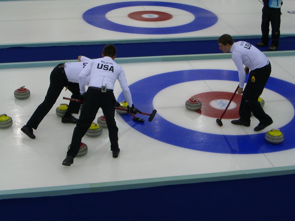men playing a curling sport