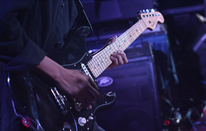 band member playing guitar